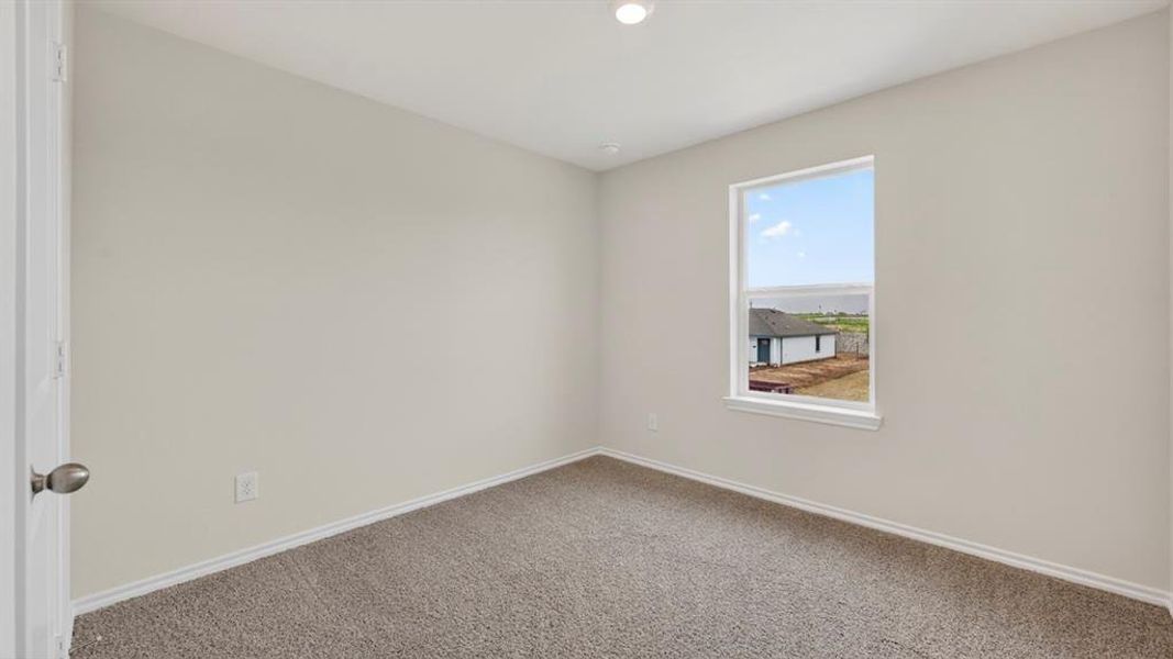 Bright room with neutral wall paint and grey carpet flooring