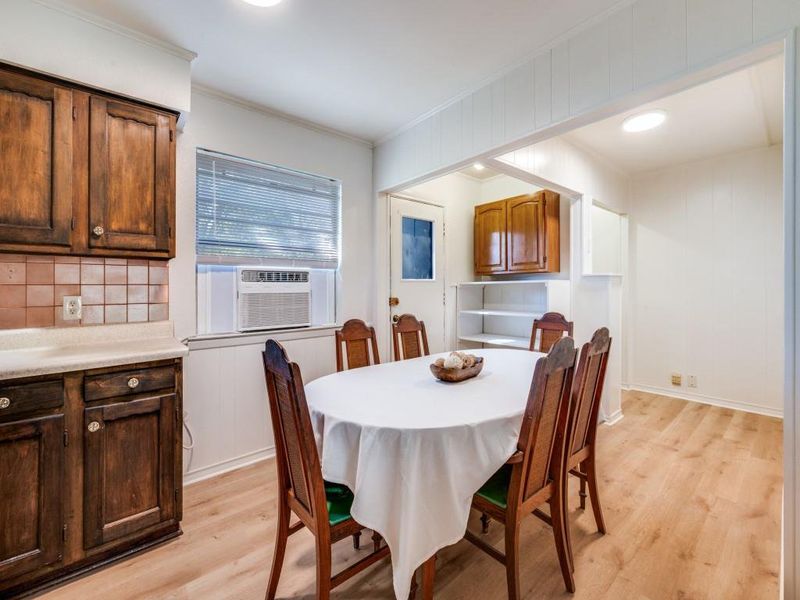 Dining space featuring light wood-type flooring, crown molding, cooling unit, and recessed lighting Dining space featuring light wood-type flooring, crown molding, cooling unit, and recessed lighting