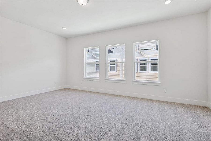 Spare room with light carpet and recessed lighting