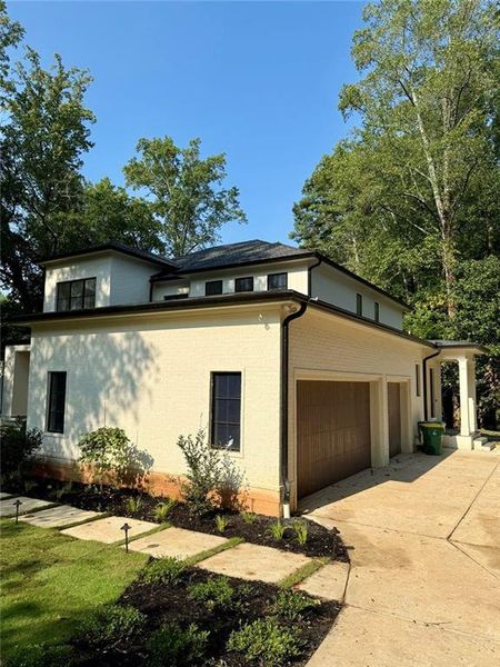 Front exterior of a new home in , Sandy Springs, GA, highlighting curb appeal (Image 1).