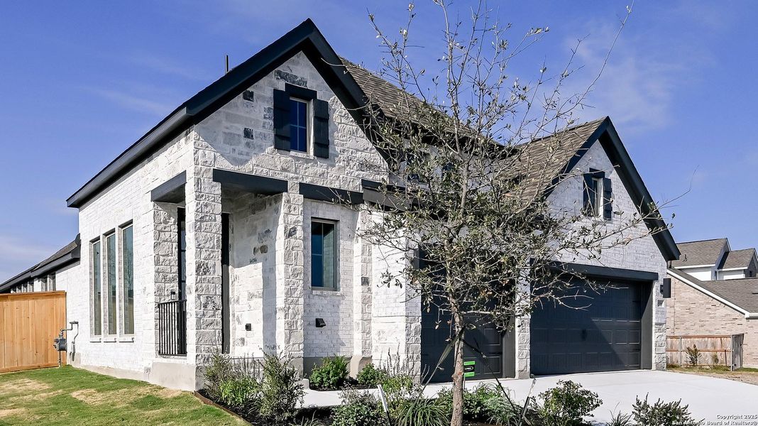 Front exterior of a new home in Mayfair 50', New Braunfels, TX, highlighting curb appeal (Image 1). Front exterior of a new home in Mayfair 50', New Braunfels, TX, highlighting curb appeal (Image 1).
