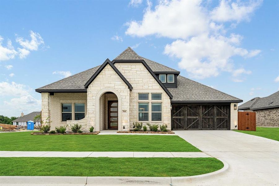 Front exterior of a new home in The Retreat at North Grove 60, Waxahachie, TX, highlighting curb appeal (Image 26). Front exterior of a new home in The Retreat at North Grove 60, Waxahachie, TX, highlighting curb appeal (Image 26).