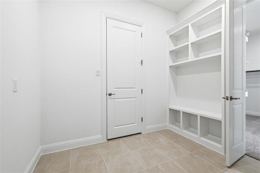 Mudroom featuring baseboards and light tile patterned flooring Mudroom featuring baseboards and light tile patterned flooring