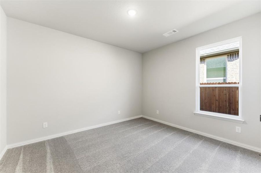 Carpeted empty room featuring baseboards