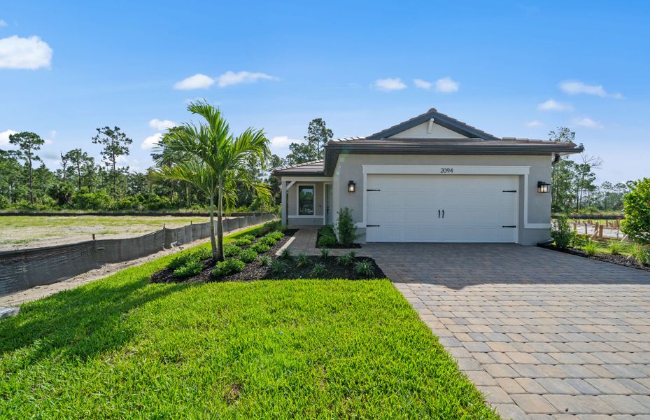 Front exterior of a new home in Terreno, Naples, FL, highlighting curb appeal (Image 1). Front exterior of a new home in Terreno, Naples, FL, highlighting curb appeal (Image 1).