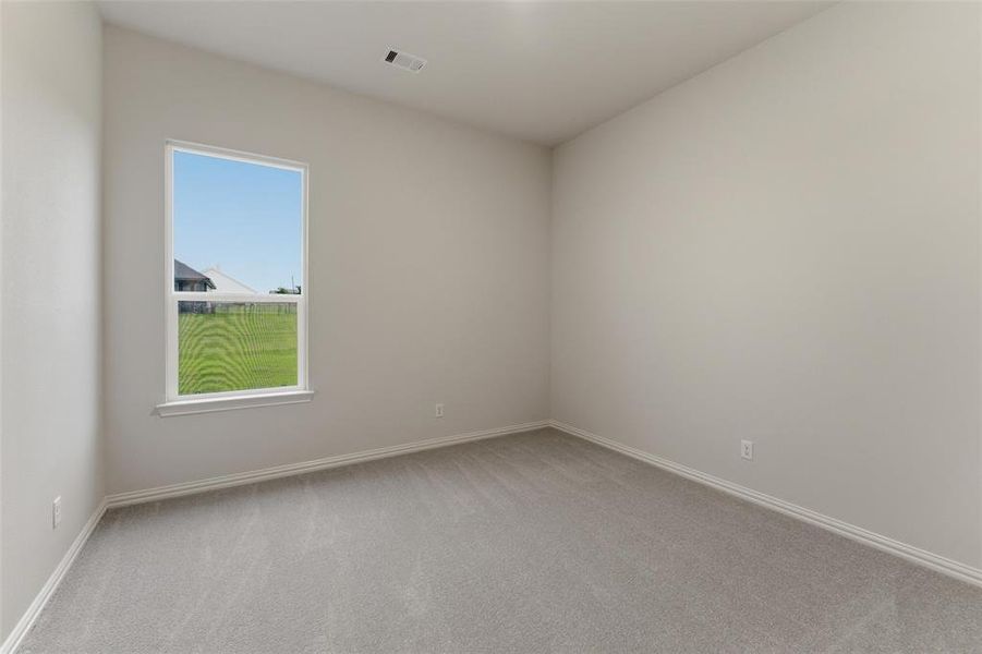 Interior room featuring neutral wall paint and grey carpeting