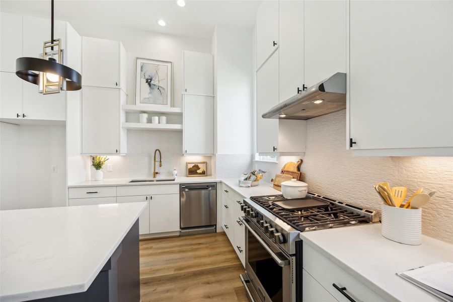 Your stunning kitchen has lots of storage space and beautiful designer tile as your backsplash. Your stunning kitchen has lots of storage space and beautiful designer tile as your backsplash.