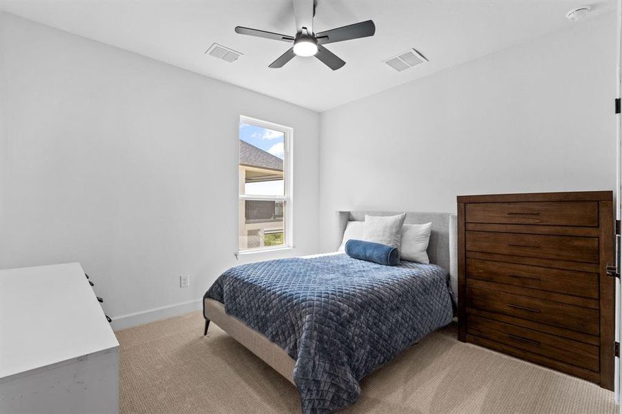 Bedroom with light colored carpet and ceiling fan Bedroom with light colored carpet and ceiling fan