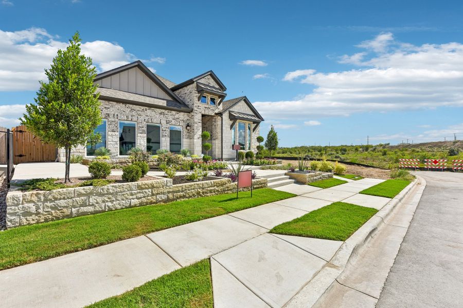 Representative exterior photo of a completed home built from the Enfield by Taylor Morrison in Village Grove, Dripping Springs, TX (Image 26).