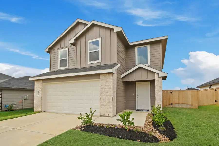 Front exterior of a new home in Mill Creek, Magnolia, TX, highlighting curb appeal (Image 1).