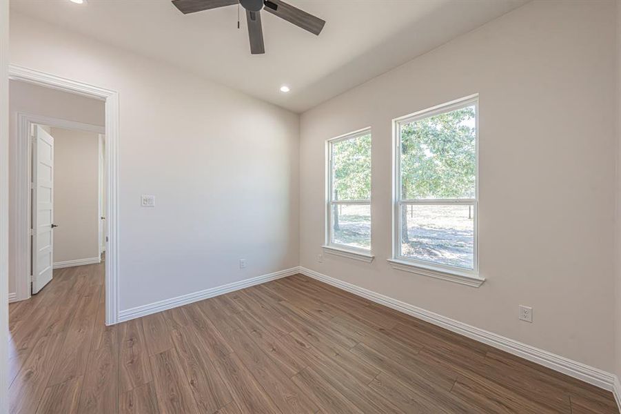 Spare room with wood finished floors, recessed lighting, and ceiling fan Spare room with wood finished floors, recessed lighting, and ceiling fan