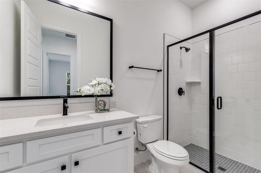 Kitchen featuring light stone counters, white cabinetry, brown cabinetry, stainless steel appliances, and light wood-type flooring Kitchen featuring light stone counters, white cabinetry, brown cabinetry, stainless steel appliances, and light wood-type flooring