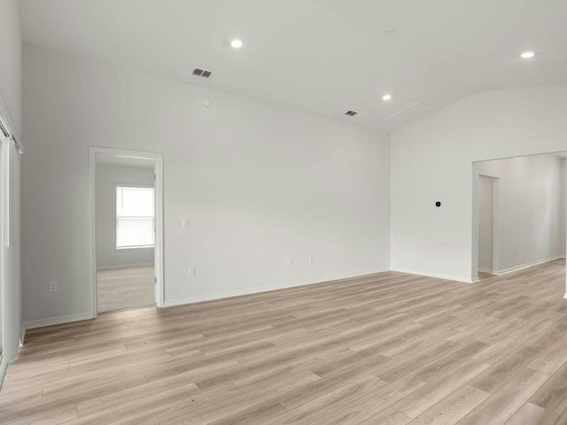 Enjoy a sunny, open living area with volume ceilings and LVP flooring.