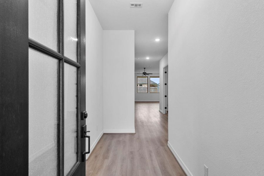 The home features a welcoming entry that flows naturally into the open living area.