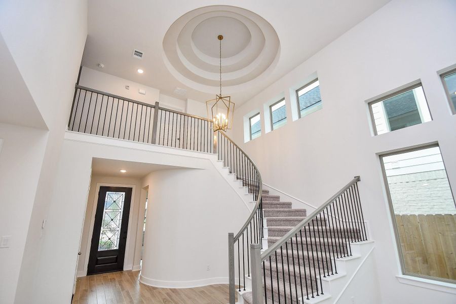A view of the open-concept living area with high ceilings and large windows, creating a bright, airy ambiance.