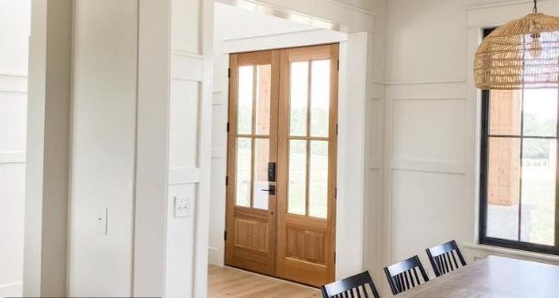 Doorway featuring french doors, hardwood / wood-style flooring, and a healthy amount of sunlight