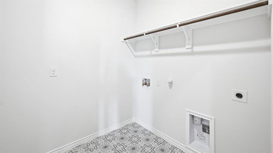 Laundry area with gas dryer hookup, hookup for an electric dryer, hookup for a washing machine, and light floors