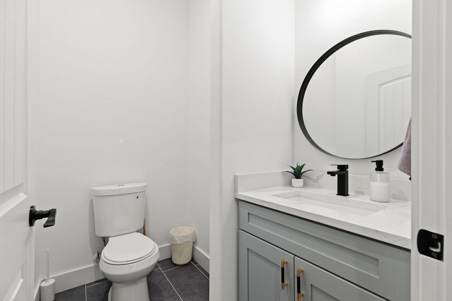 Bathroom featuring vanity and dark tile patterned flooring