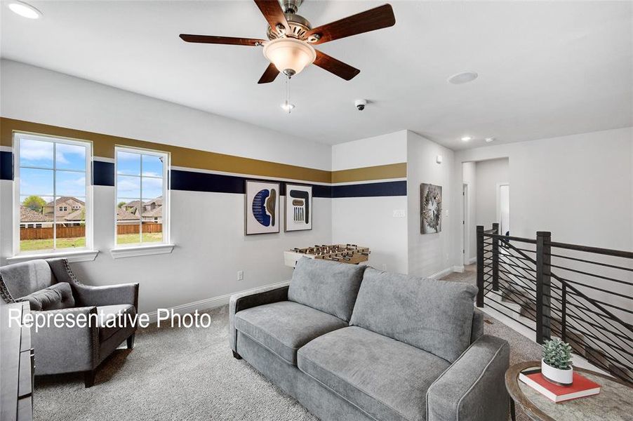 Living room featuring ceiling fan and carpet floors