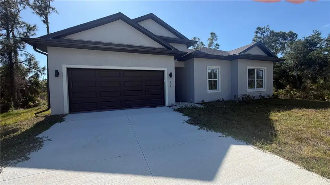 Front exterior of a new home in , Port Charlotte, FL, highlighting curb appeal (Image 1). Front exterior of a new home in , Port Charlotte, FL, highlighting curb appeal (Image 1).