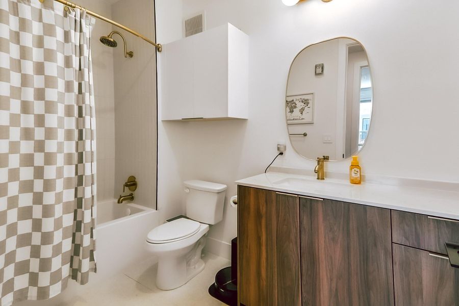 Full bath featuring vanity and shower / tub combo with curtain
