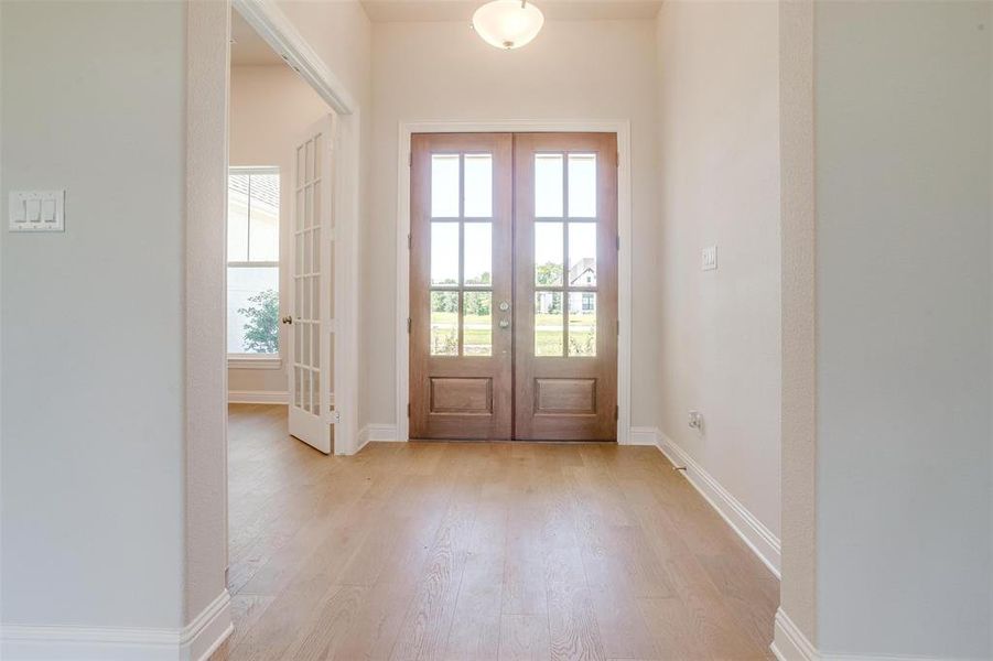 Doorway featuring french doors and light hardwood / wood-style flooring