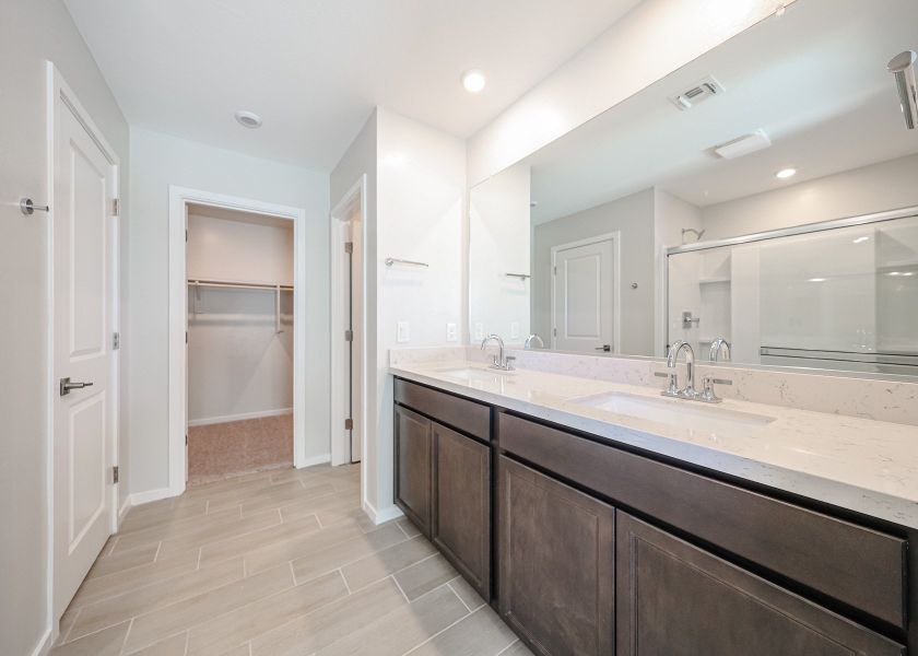 A bathroom with a large mirror.