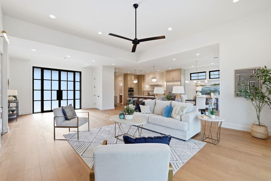 Living area with ceiling fan, light wood-type flooring, and recessed lighting