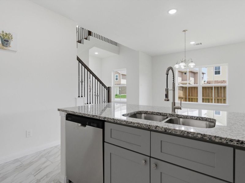 Designed for both connection and comfort, the seamless transition from the kitchen to the living space makes gathering and entertaining feel effortless. Designed for both connection and comfort, the seamless transition from the kitchen to the living space makes gathering and entertaining feel effortless.