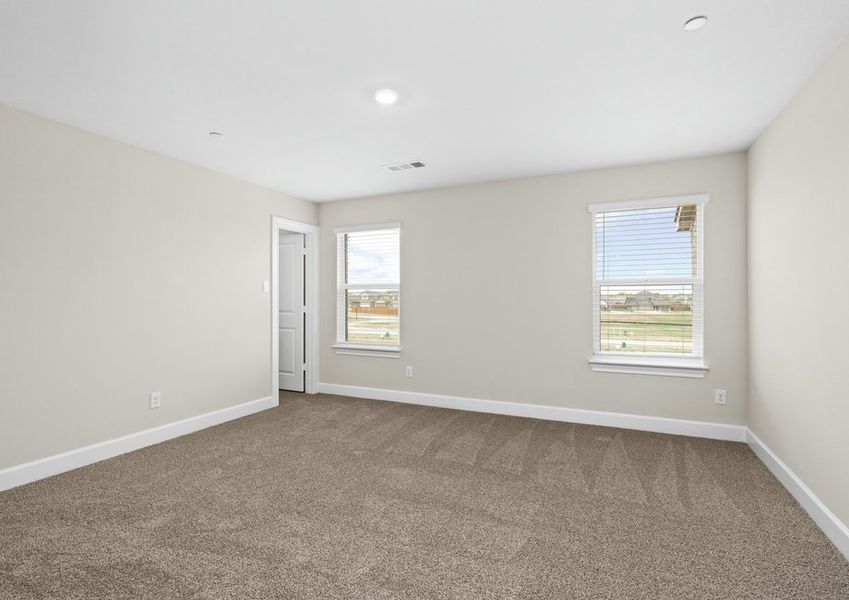The master bedroom has large windows that let in great, natural light.