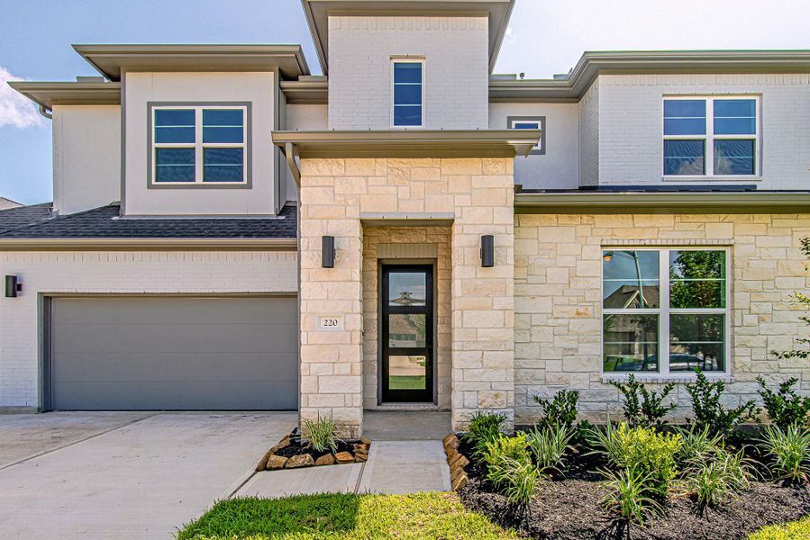 Welcoming front entry with contemporary exterior finishes Welcoming front entry with contemporary exterior finishes