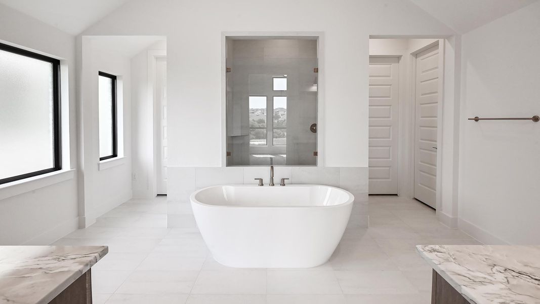 Unfurnished room featuring light carpet, baseboards, and vaulted ceiling