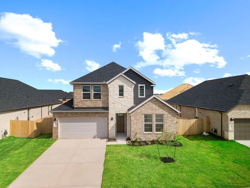 Front exterior of a new home in Westland Ranch 50' Homesites, League City, TX, highlighting curb appeal (Image 2).