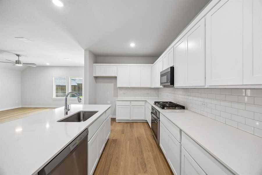 Kitchen in the Oscar home plan by Trophy Signature Homes – REPRESENTATIVE PHOTO