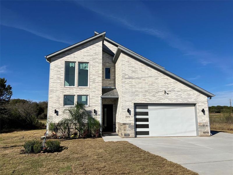 Front exterior of a new home in , Whitney, TX, highlighting curb appeal (Image 20). Front exterior of a new home in , Whitney, TX, highlighting curb appeal (Image 20).