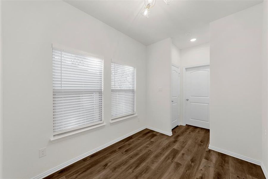 Unfurnished room with dark wood-type flooring