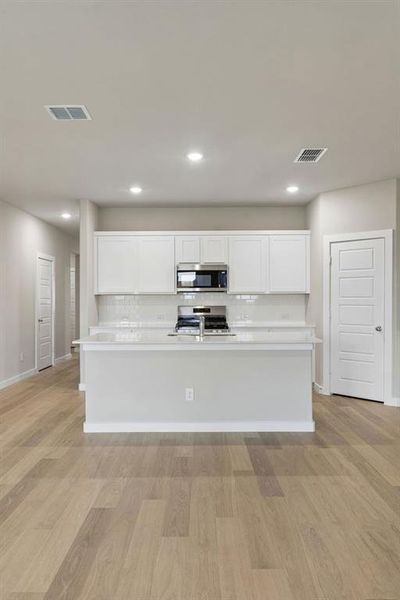 Kitchen in the Emmy II home plan by Trophy Signature Homes - REPRESENTATIVE PHOTO