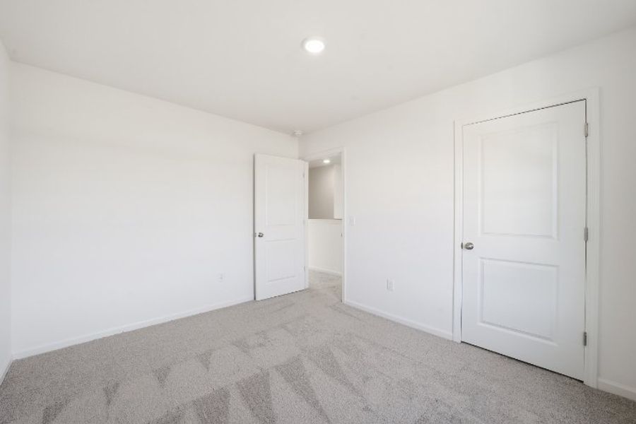 A hallway with white doors.