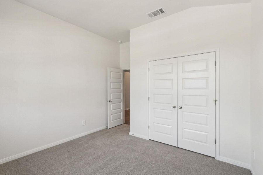 Unfurnished bedroom featuring carpet floors and a closet Unfurnished bedroom featuring carpet floors and a closet