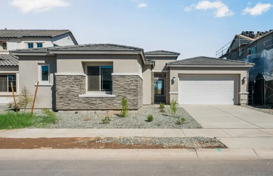 Front exterior of a new home in Legado West, Queen Creek, AZ, highlighting curb appeal (Image 2). Front exterior of a new home in Legado West, Queen Creek, AZ, highlighting curb appeal (Image 2).