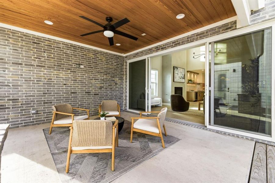 View of patio / terrace featuring a ceiling fan and an outdoor living space