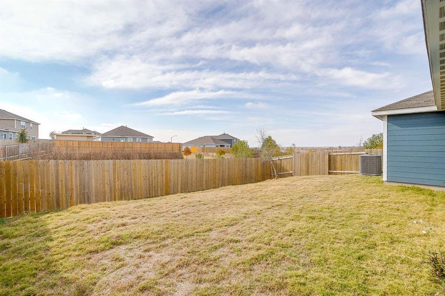 Fenced backyard featuring a residential view