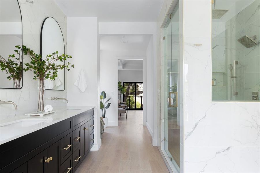 Bathroom with walk in shower, dual bowl vanity, and hardwood / wood-style floors