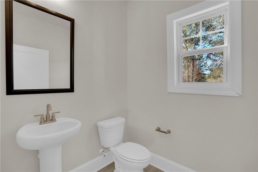 This serene bathroom offers essential fixtures and This serene bathroom offers essential fixtures and