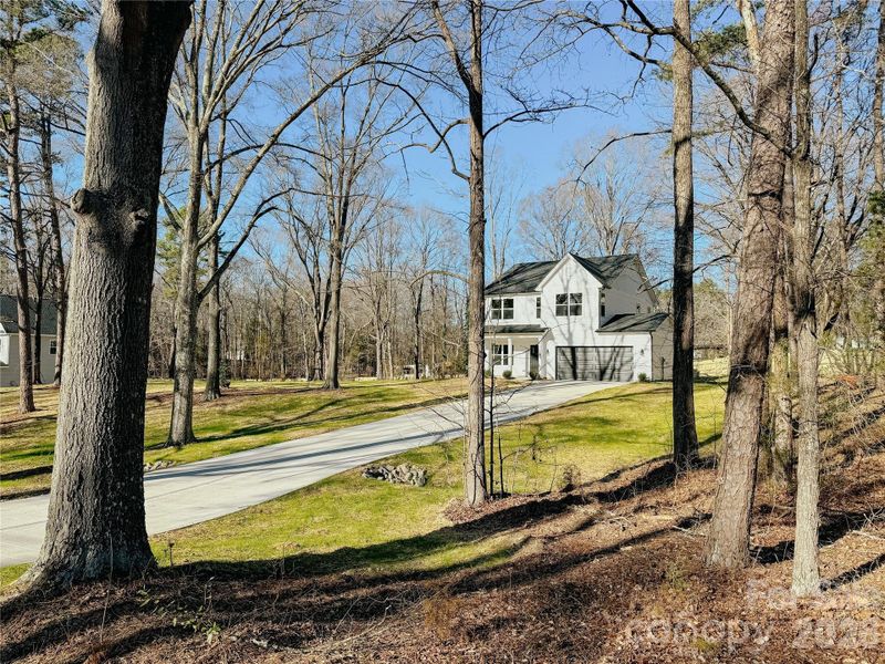 Front exterior of a new home in , Huntersville, NC, highlighting curb appeal (Image 21).