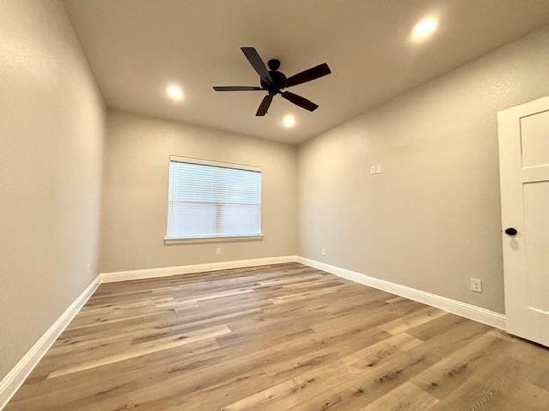 Empty room with ceiling fan and hardwood / wood-style floors