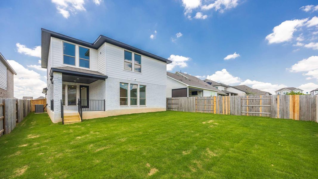 Rear view of house featuring a fenced backyard, brick siding, and a residential view Rear view of house featuring a fenced backyard, brick siding, and a residential view