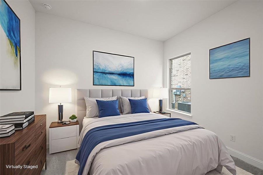 Bedroom featuring light carpet and baseboards Bedroom featuring light carpet and baseboards