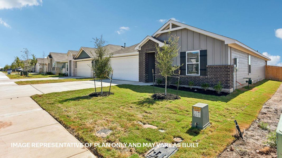 Front exterior of a new home in Carillon, Manor, TX, highlighting curb appeal (Image 18). Front exterior of a new home in Carillon, Manor, TX, highlighting curb appeal (Image 18).