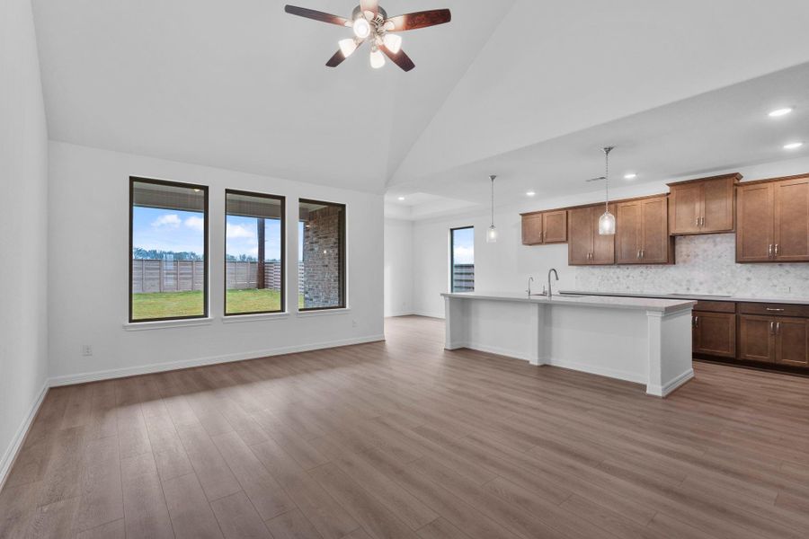 Oversized windows in the family room allow ample light in this open concept living space.